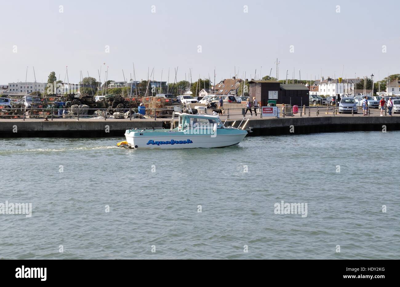 A small motor boat passes Mudeford Quay, Dorset, and heads out to sea.England Stock Photo