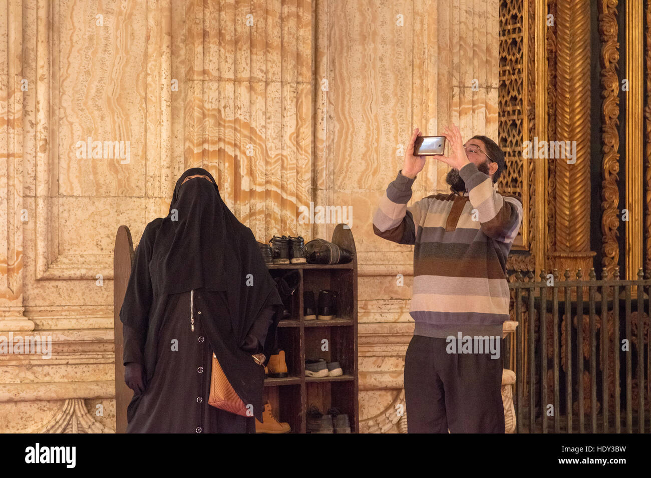 Muslim man and his hijab wife in the mosque of Muhammad Ali, Cairo, Egypt Stock Photo