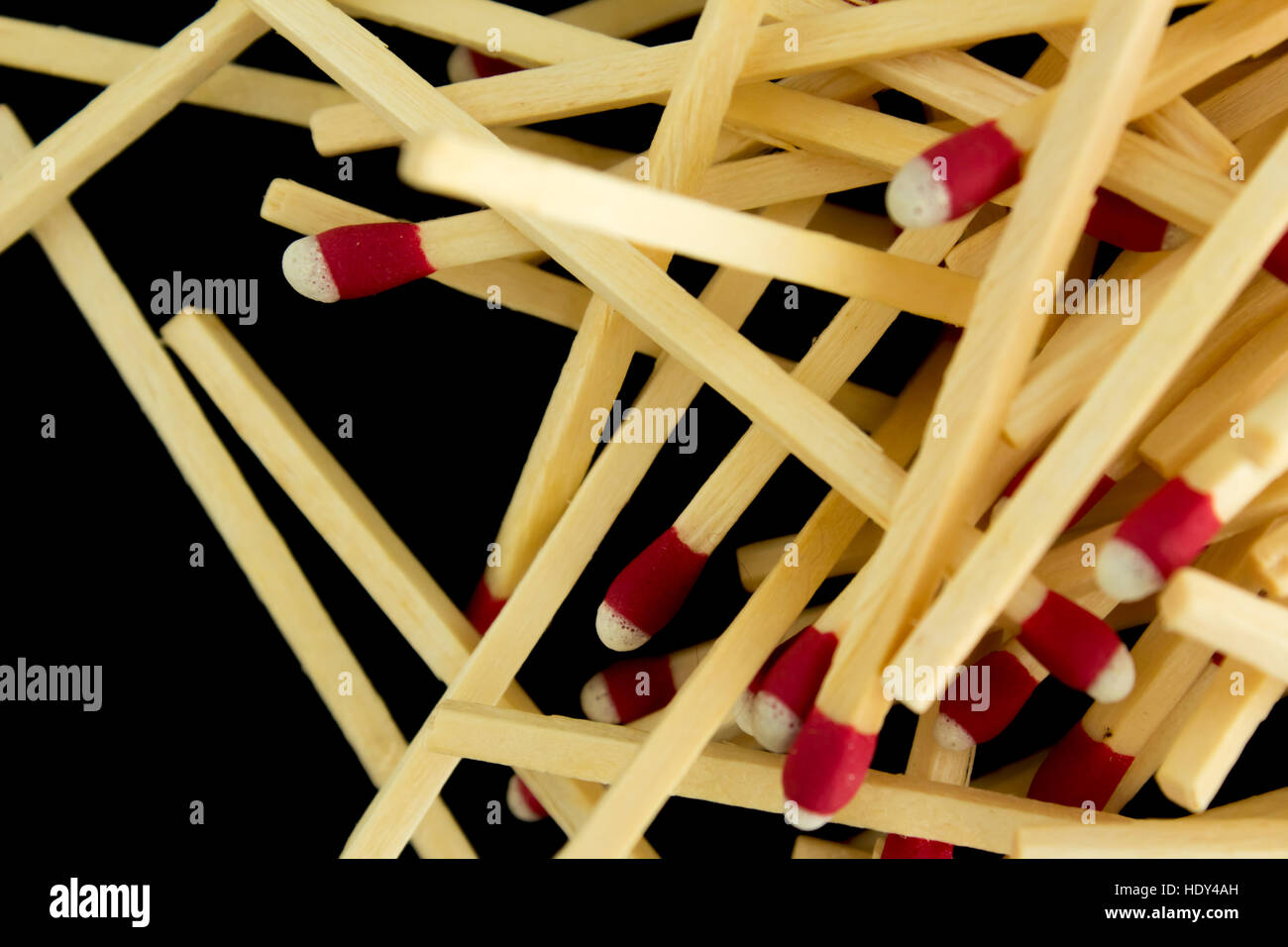 A pile of strike-anywhere matches isolated on a black background, very close up Stock Photo
