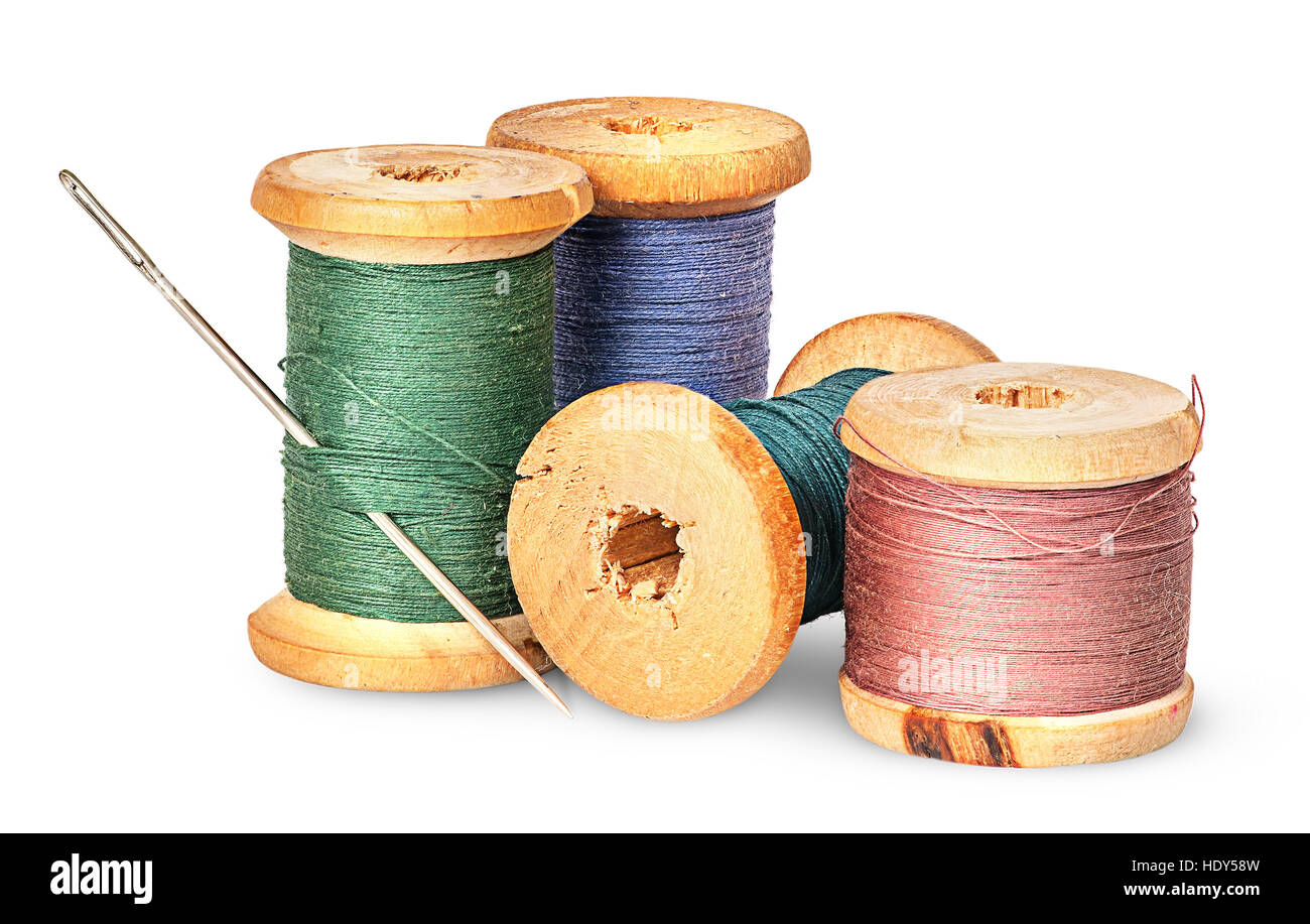 Needle and multicolored thread on wooden spool isolated on white background Stock Photo