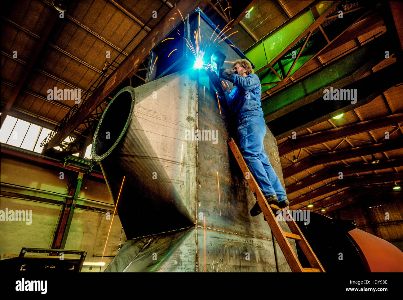 Arc welder working on a furnace unit in a German machine factory. Stock Photo