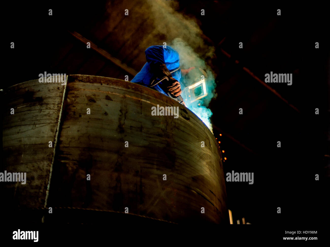Arc welder working on a furnace unit in a German machine factory Stock