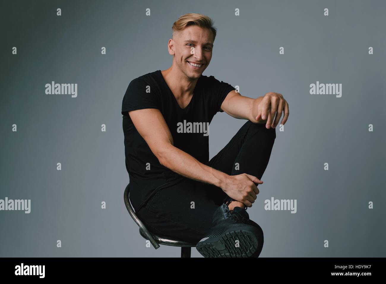 Handsome blond young man posing at studio Stock Photo - Alamy