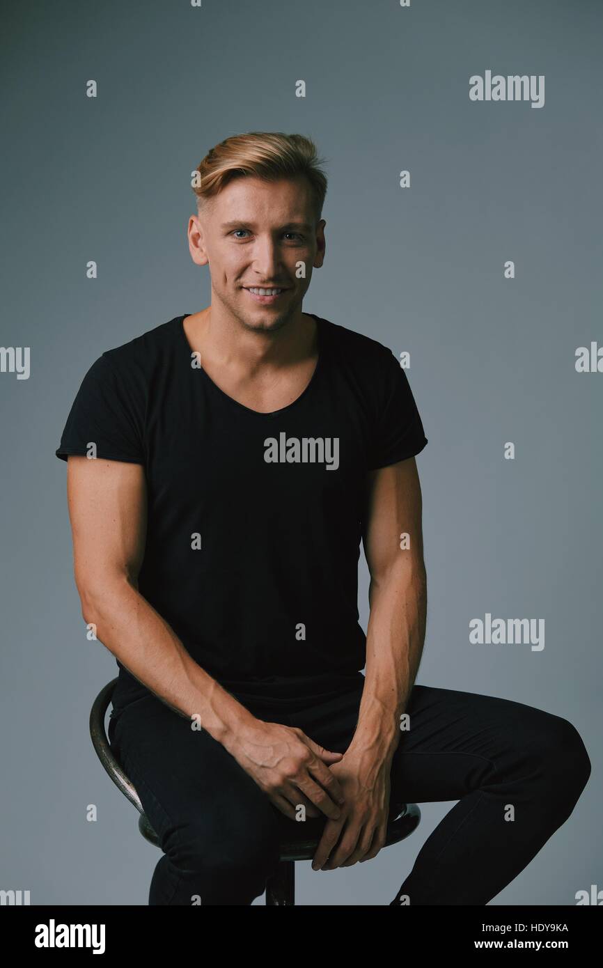 Handsome blond young man posing at studio Stock Photo - Alamy