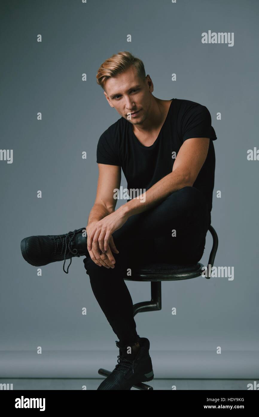 Handsome blond young man posing at studio Stock Photo - Alamy