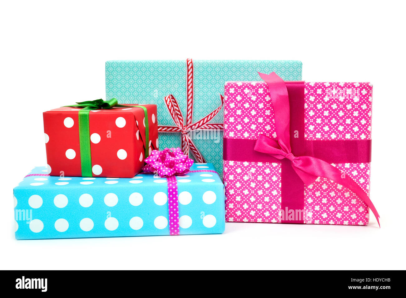 closeup of a pile of gifts wrapped in nice papers and tied with ribbons of different colors on a white background Stock Photo