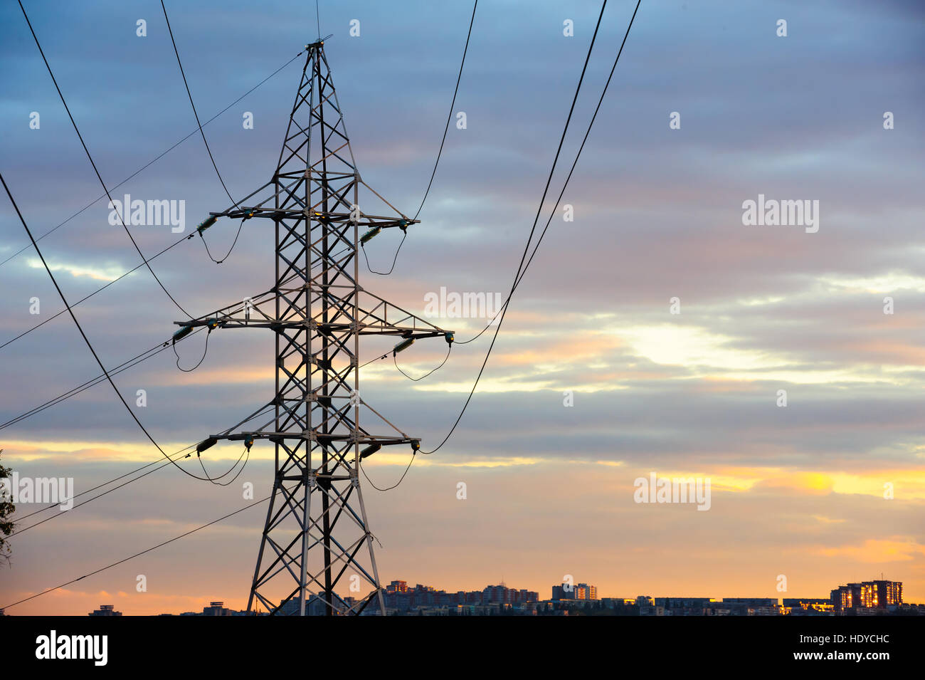 Electricity pylons and power lines silhouettes at a cloudy sunset Stock ...