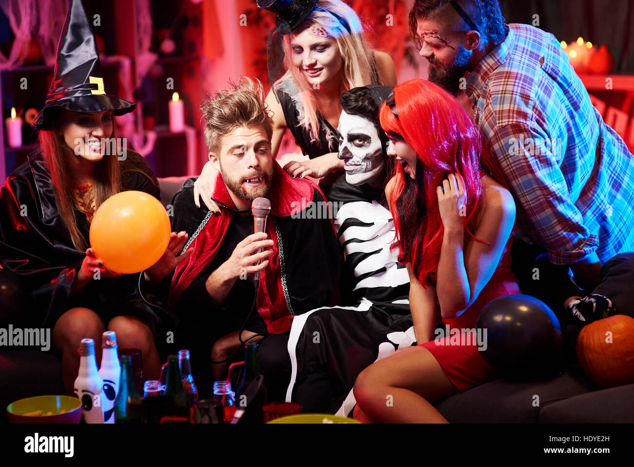 Vampire singing at halloween party Stock Photo