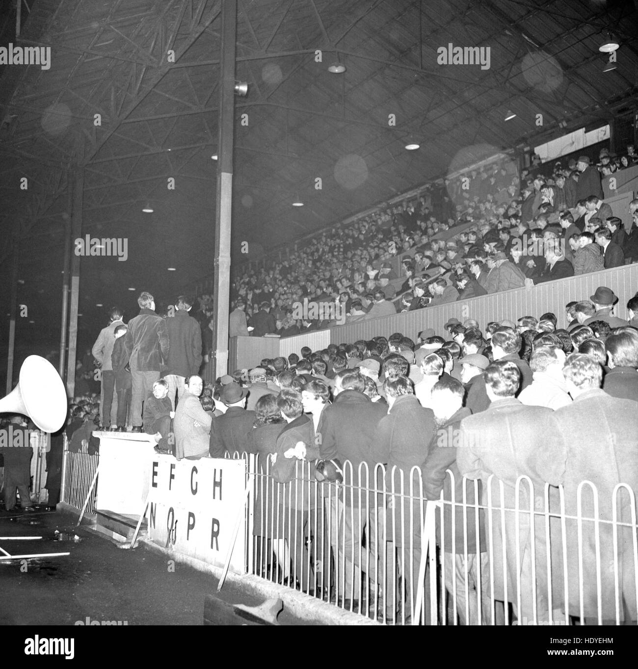A crowd of Brentford FC supporters at a meeting held at Griffin Park as part of the campaign to counter the Queen's Park Rangers takeover bid for the club. Speakers are seen using the directors' box. People at the meeting who were willing to buy Ordinary Shares at 10s were each asked to state on a form the number of shares they would purchase. Stock Photo