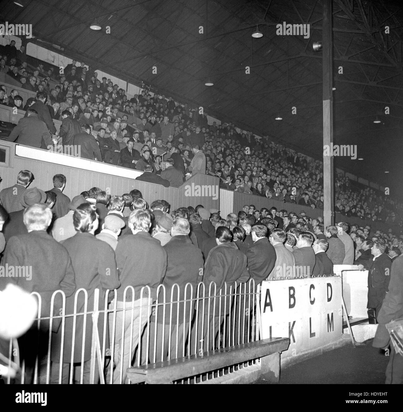 A crowd of Brentford FC supporters at a meeting held at Griffin Park as part of the campaign to counter the Queen's Park Rangers takeover bid for the club. Speakers are seen using the directors' box. People at the meeting who were willing to buy Ordinary Shares at 10s were each asked to state on a form the number of shares they would purchase. Stock Photo