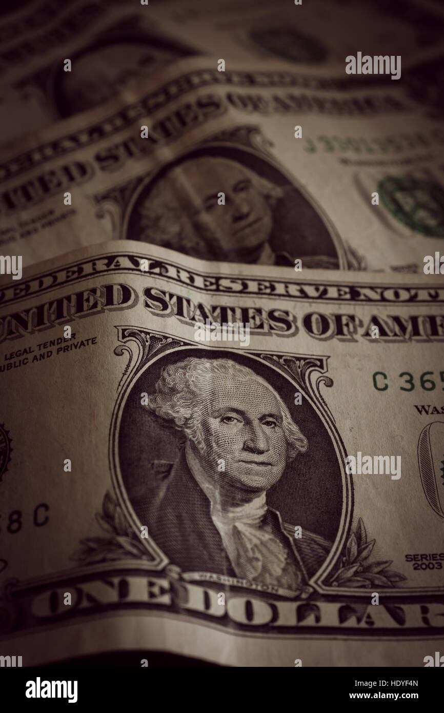 Old and crumpled United States one dollar bank notes photographed with shallow focus and an antique filter applied to the image Stock Photo