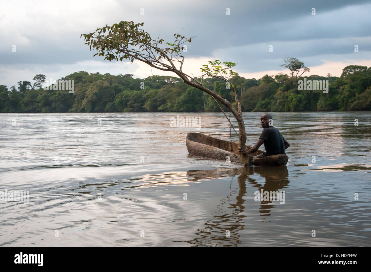 Fisherman in canoe on Moa River, Sierra Leone Stock Photo