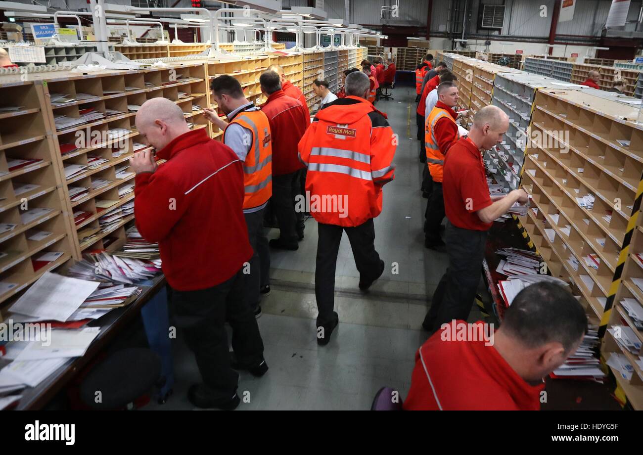 Royal Mail staff sort mail at the Royal Mail's Sorting Office in Turner Road, Glasgow, where postal workers are handling some of the millions of items of Christmas mail on what is expected to be one of their busiest day of the year. Stock Photo