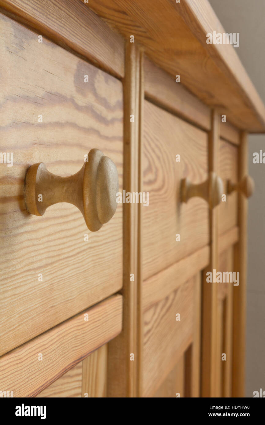 closeup of three drawers of a vintage wooden cabinet or a chest with knobs, natural brown color, symbol for orderliness Stock Photo