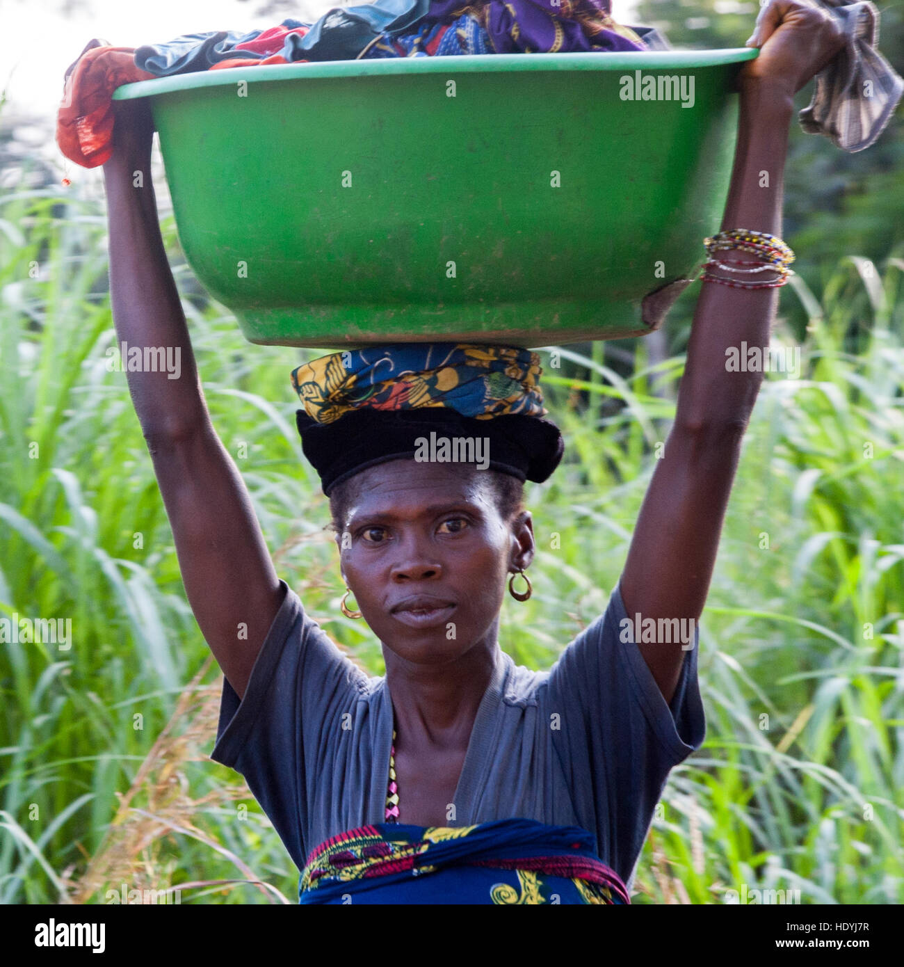 African woman carrying bowl on her head Stock Photo
