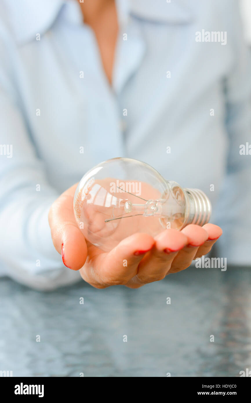 Businesswoman holding in hand a light bulb Stock Photo