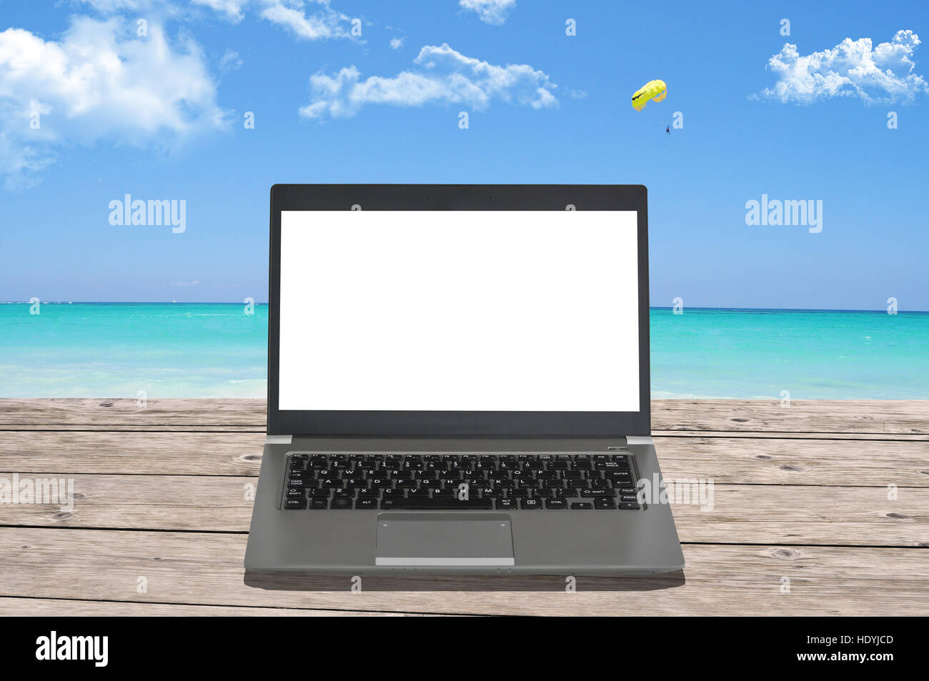 Blank screen of notebook computer on a perfect beach Stock Photo