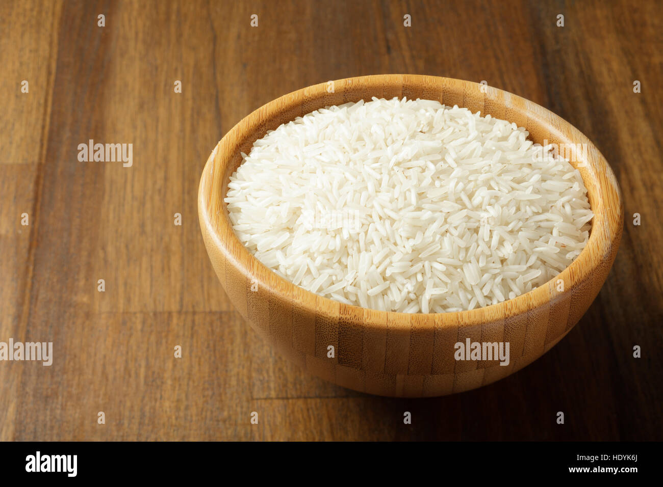 White rice in a wooden bowl Stock Photo