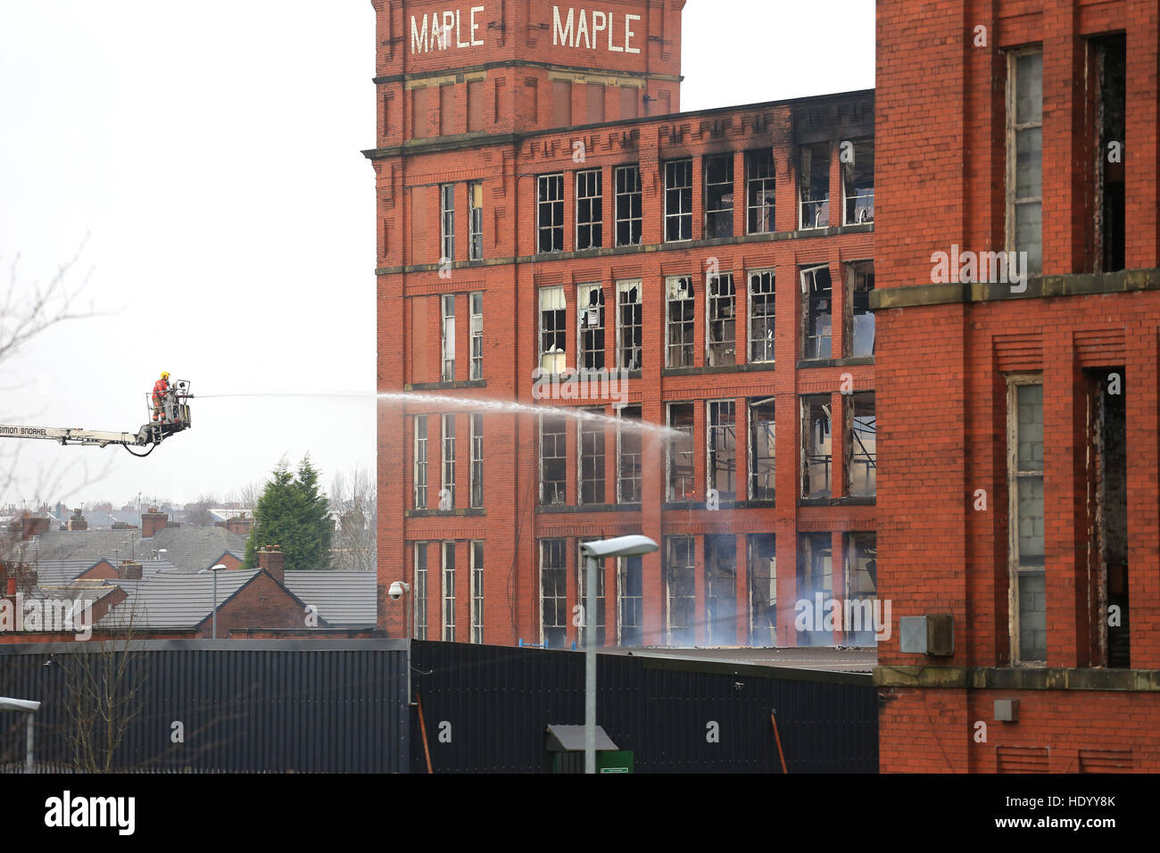 Oldham, UK. 15th Dec, 2016. A fire hose pointing at a mill which is on
