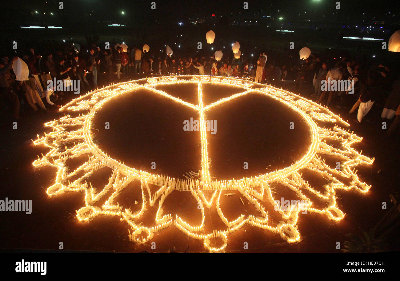 Lahore. 16th Dec, 2016. Pakistanis light candles marking the second