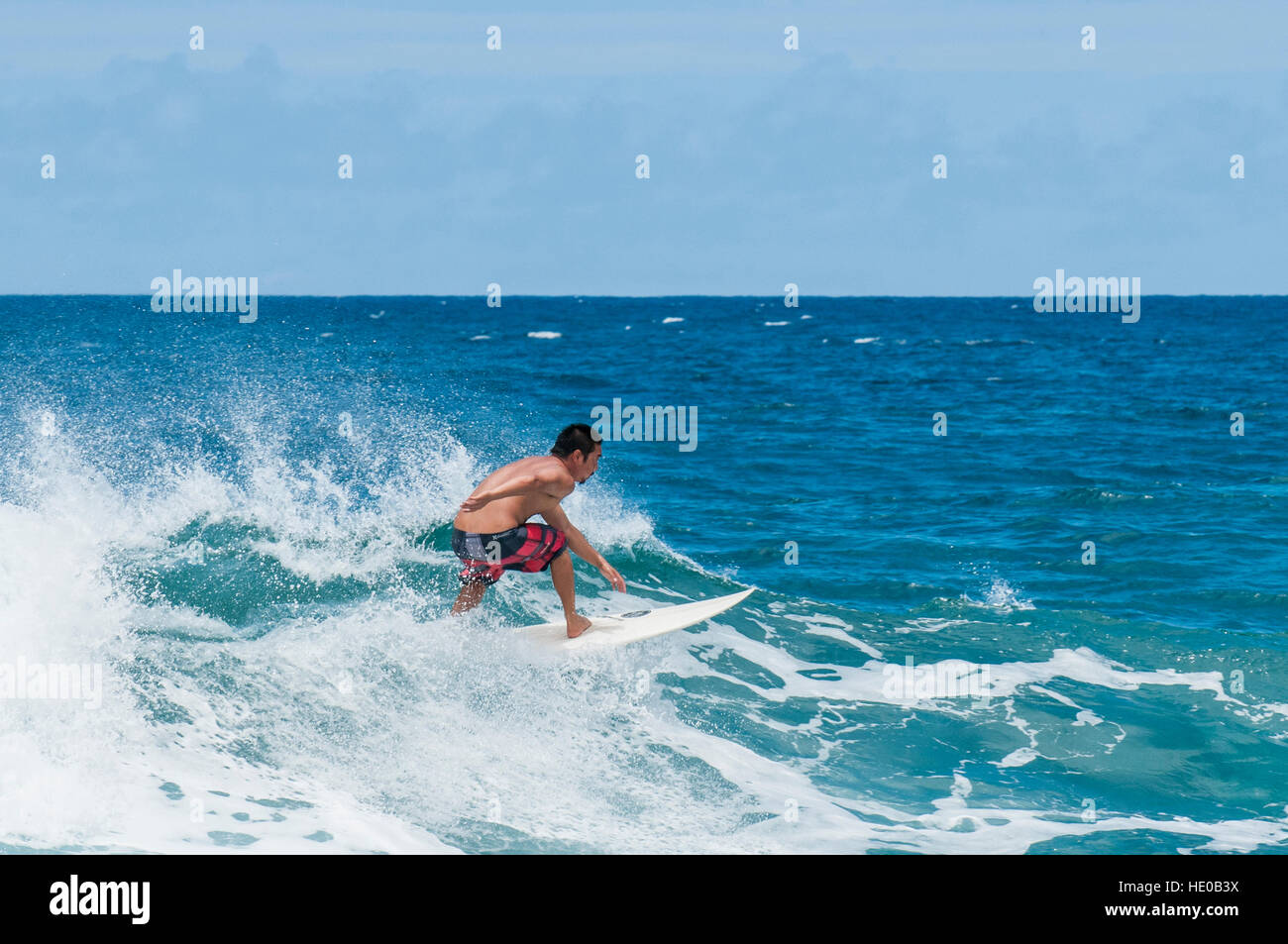 Surfing at Sunset Beach, North Shore, Oahu, Hawaii. Stock Photo