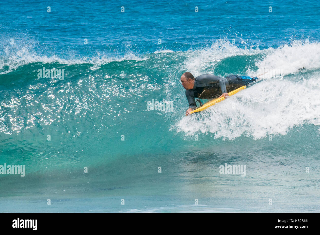 Boogie boarding riding wave at Sunset Beach, North Shore, Oahu, Hawaii