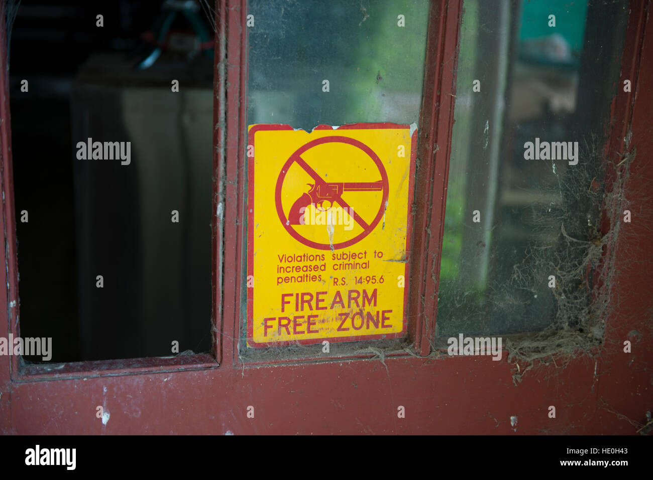 A Gun Free Zone sign on the door of an abandoned school in Louisiana. Stock Photo