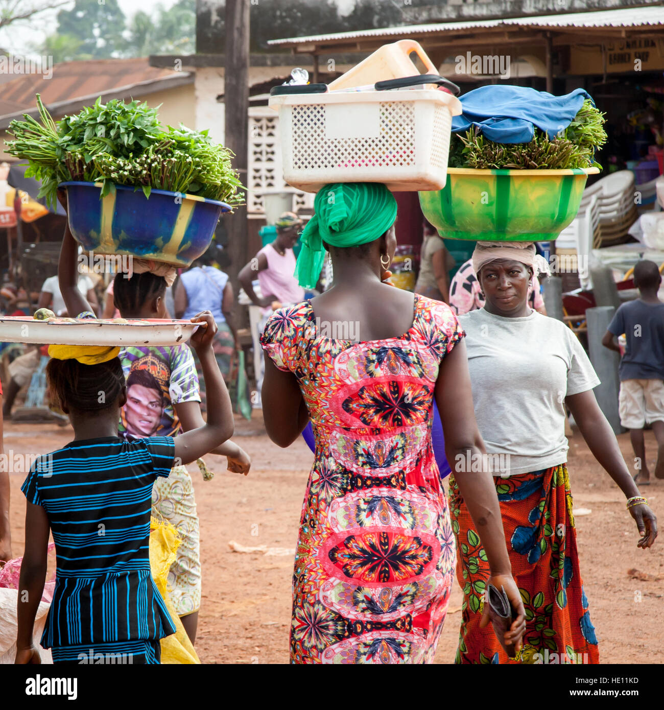 African women carrying trays and bowls Stock Photo
