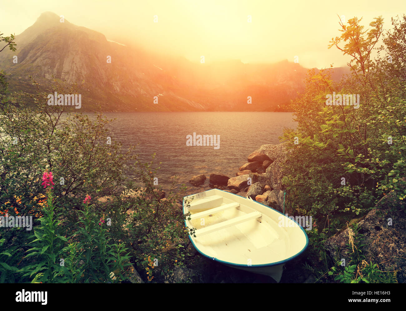 Autumn misty morning. Boat on the river bank. Beautiful ford, Norway ...