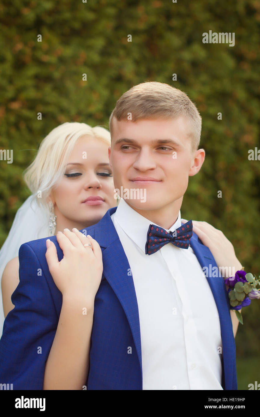 The bride groom gently hugged the shoulders Stock Photo