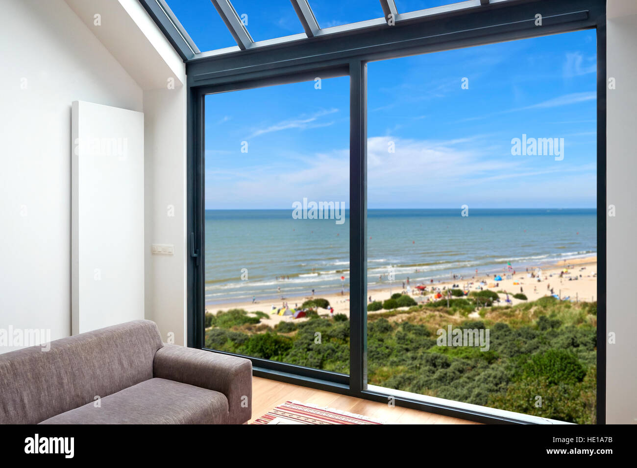Modern living room with large windows and view on seaside Stock Photo ...