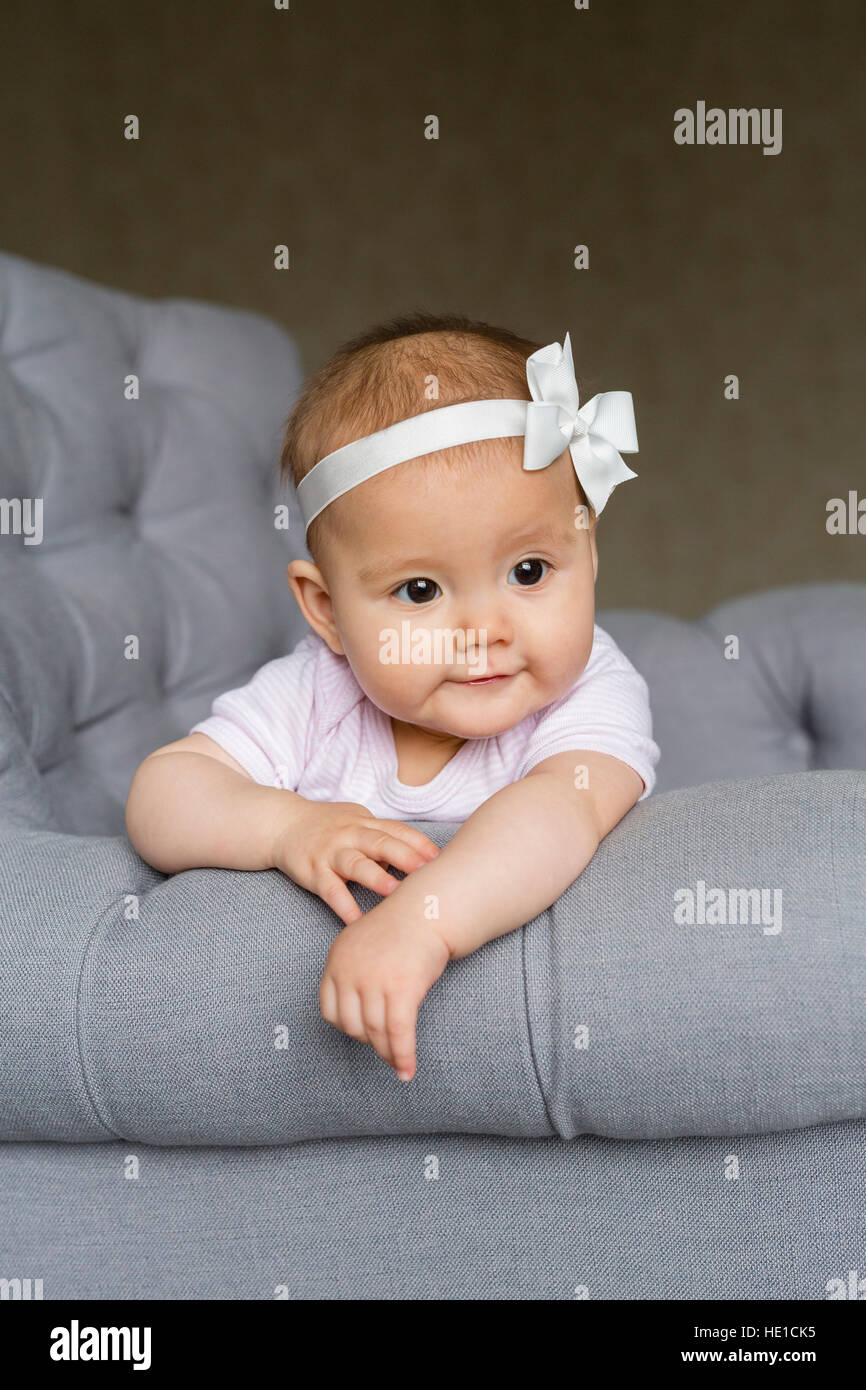 Baby girl on an armchair Stock Photo Alamy