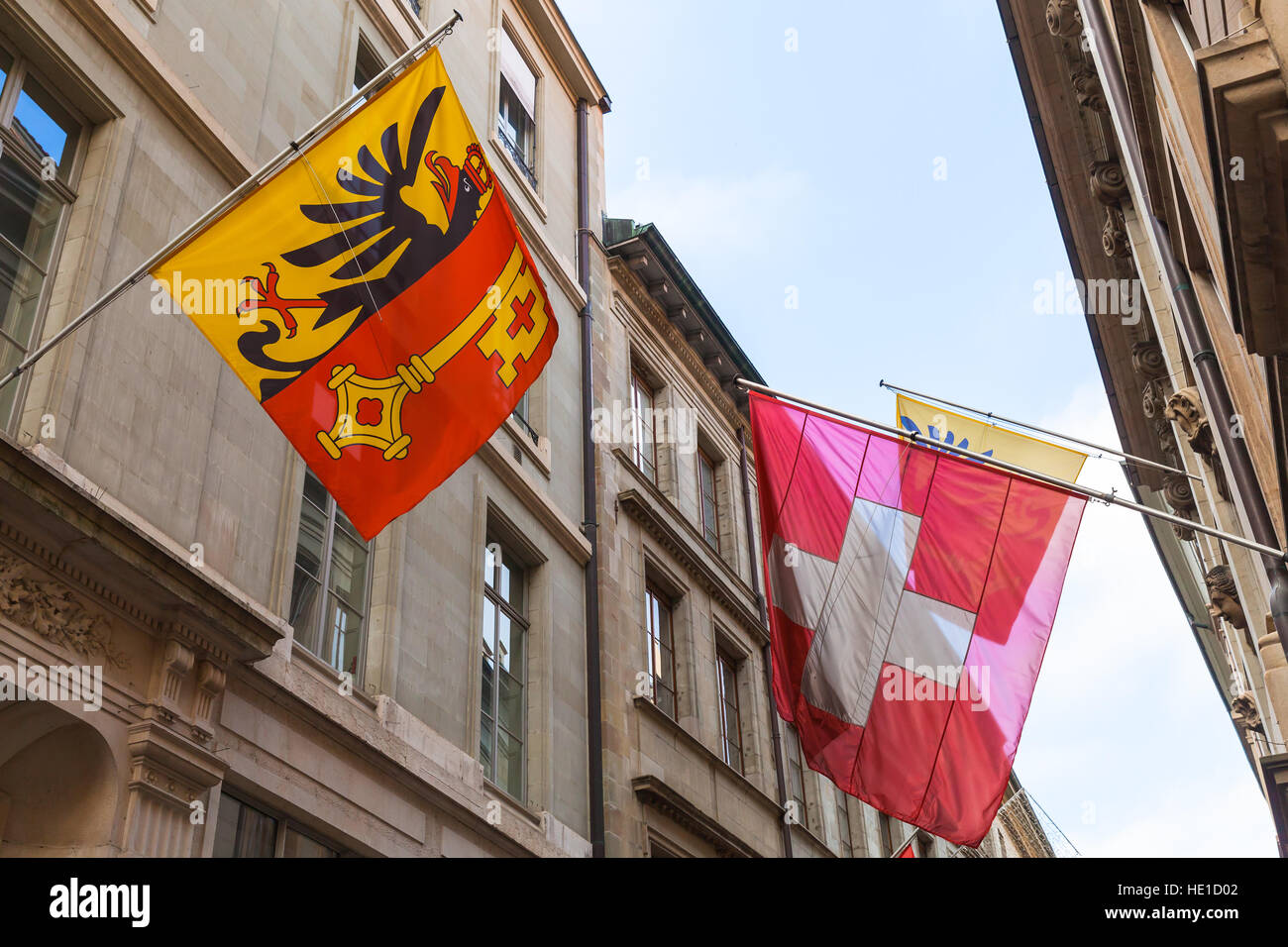 Geneva, Switzerland. Swiss National and City flags mounted on old house wall Stock Photo