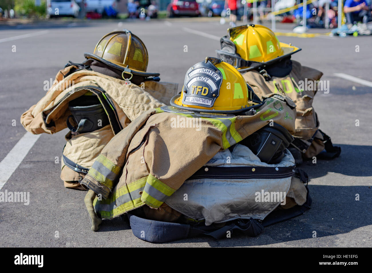 Firefighter helmets and turn out coats stacked on top of other equipment belonging to Troy Alabama USA, Fire Rescue. Stock Photo