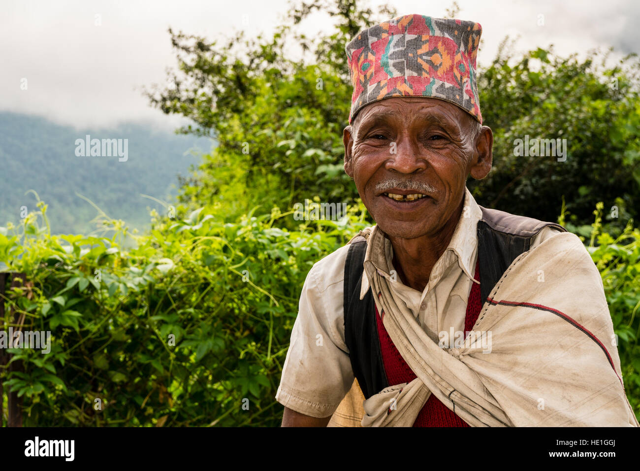 Portrait of an wrinkled, old local man, wearing the traditional hat, the Dhaka Topi Stock Photo