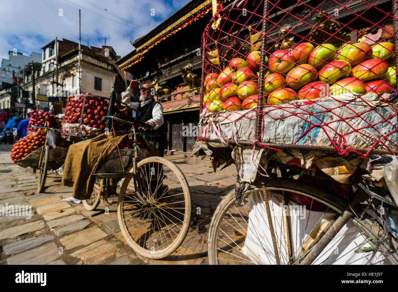 Fruit sellers, using bicycles, are offering apples and oranges on Indra Chowk in front of Akash Bhairab temple Stock Photo