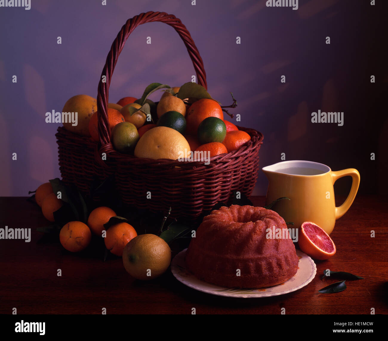 Fruit basket and orange cake. Stock Photo