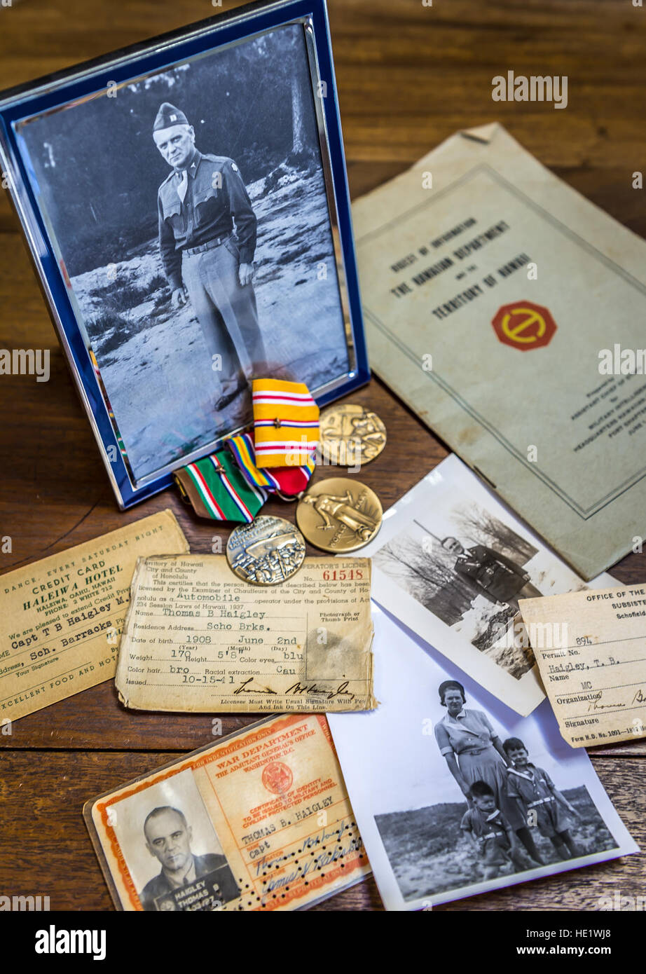 Thomas Brien Haigley Jr., 79, displays his collection of photos, medals and other effects that belonged to father, Thomas Brien Haigley Sr. Haigley Sr. was a captain and doctor in the U.S. Army Medical Corps, had left his son on the porch of their home, near Generals Loop at neighboring Schofield Barracks, to report to the base hospital during the Japanese attack on Dec 7, 1941. From there he was sent to the mess hall at Wheeler Field. The building, which stands little changed today, was directly across the street from where a Japanese bomb had torn through the roof of Hanger 3, igniting stack Stock Photo