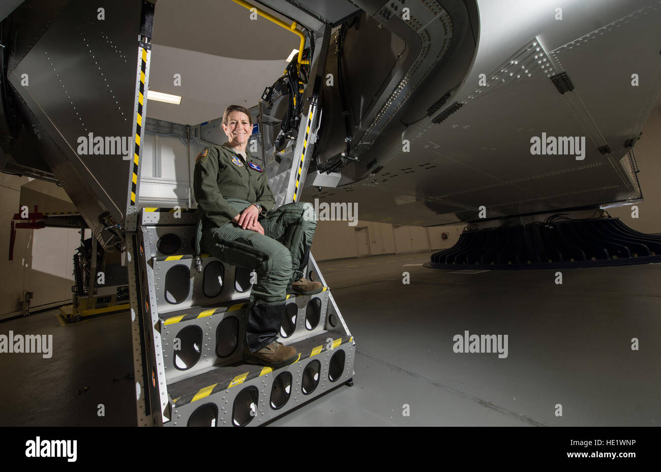 Col. Kathryn Hughes, a pilot-physician and director, Human Systems Integration, 711th Human Performance Wing, sits on the stairs of a centrifuge at Wright-Patterson Air Force Base, Ohio, April 22, 2016. Hughes, an A-10 Thunderbolt II pilot, was instrumental in the integration of the full-coverage G-suit into the Air Force inventory. /Master Sgt. Brian Ferguson Stock Photo