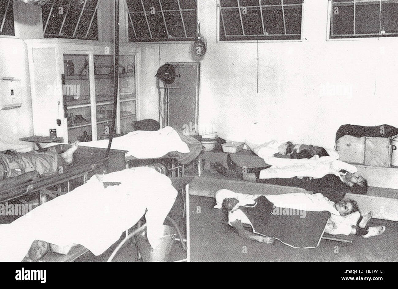 Civilian casualties lie in a makeshift first-aid center. Sixty- eight civlians were killed and 35 wounded, nearly all by falling anti-aircraft artillery rounds. Stock Photo