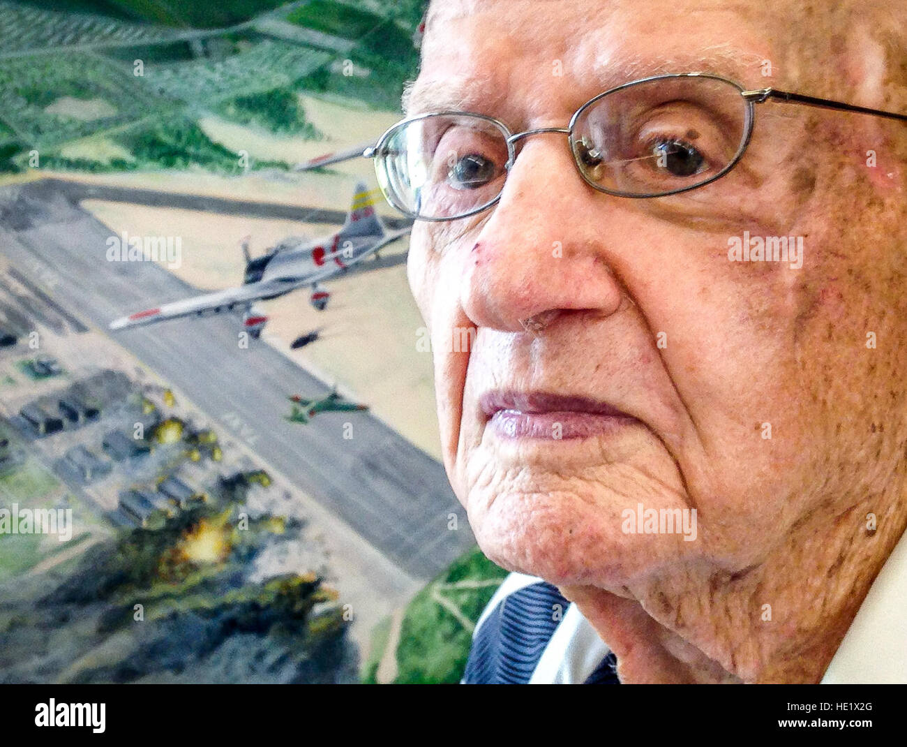 Col. Andrew Kowalski, US Army retired, 101, is photographed next to a painting in the 15th Wing Headquarters Building at Hickam Field at Joint Base Pearl Harbor Hickam, Aug 8, 2016. The painting depicts the Japanese aerial attack on Hickam Field on Oahu Island, Hawaii, Dec 7, 1941; part of the overall surprise attack to destroy the U.S. Navy Pacific Fleet anchored at Pearl Harbor. Kowalski was a first sergeant at the time and was tasked with keeping records of the dead and wounded at Hickam Field.  J.M. Eddins Jr. Stock Photo