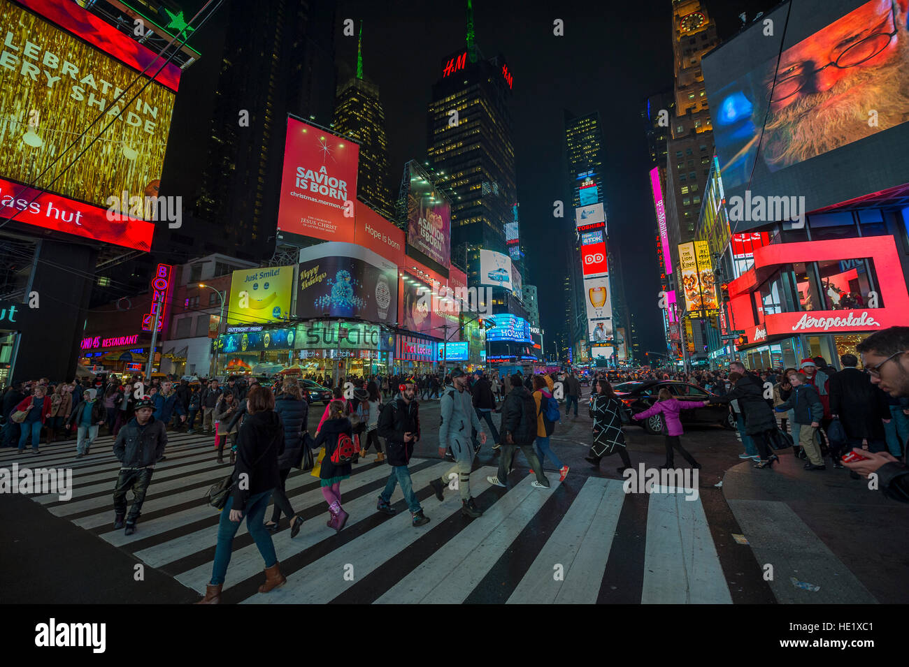 NEW YORK CITY - DECEMBER 22, 2015: Crowds gather under the bright lights of Times Square in the build-up to New Year's Eve. Stock Photo