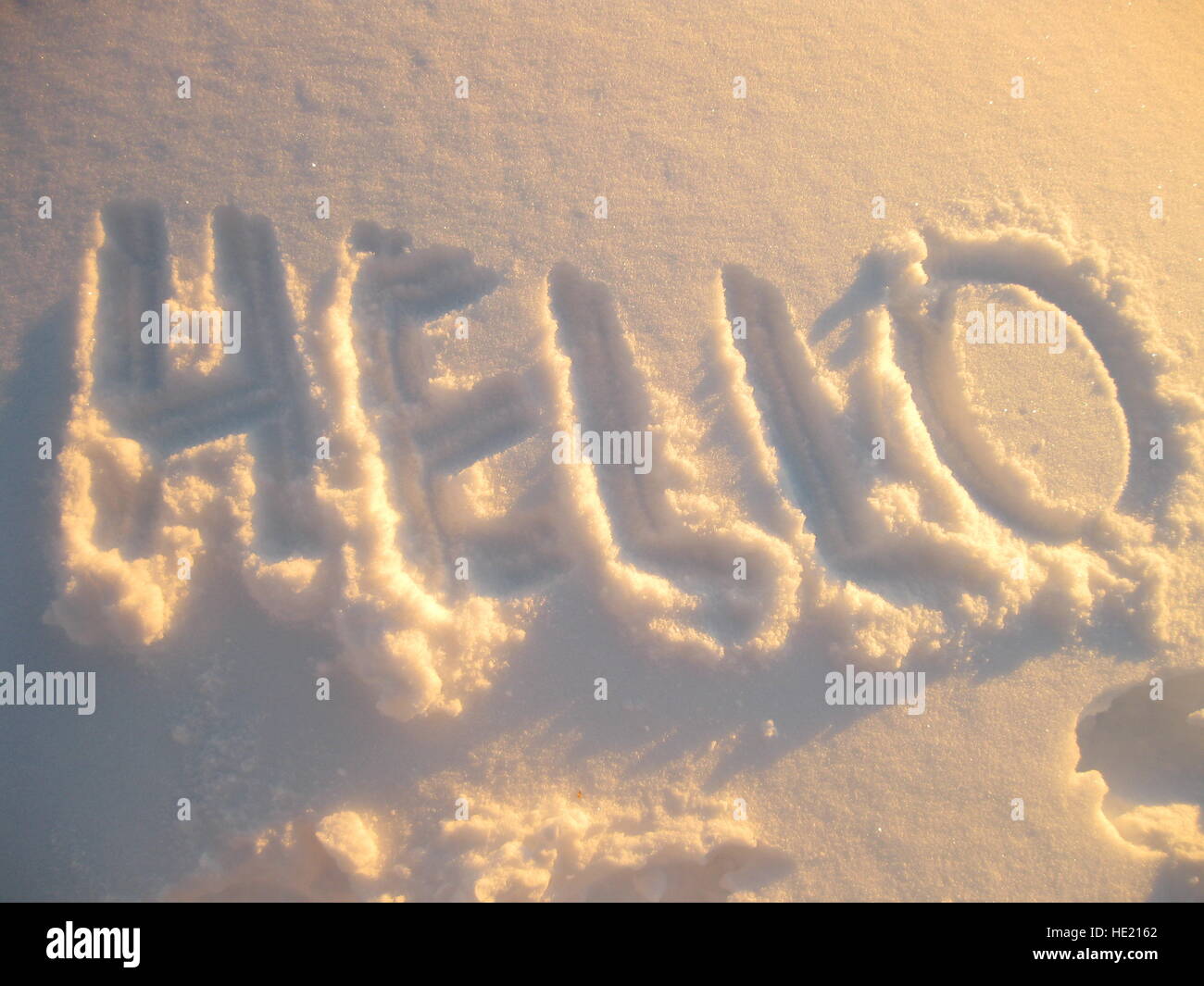 Hello written in snow with evening lighting Stock Photo