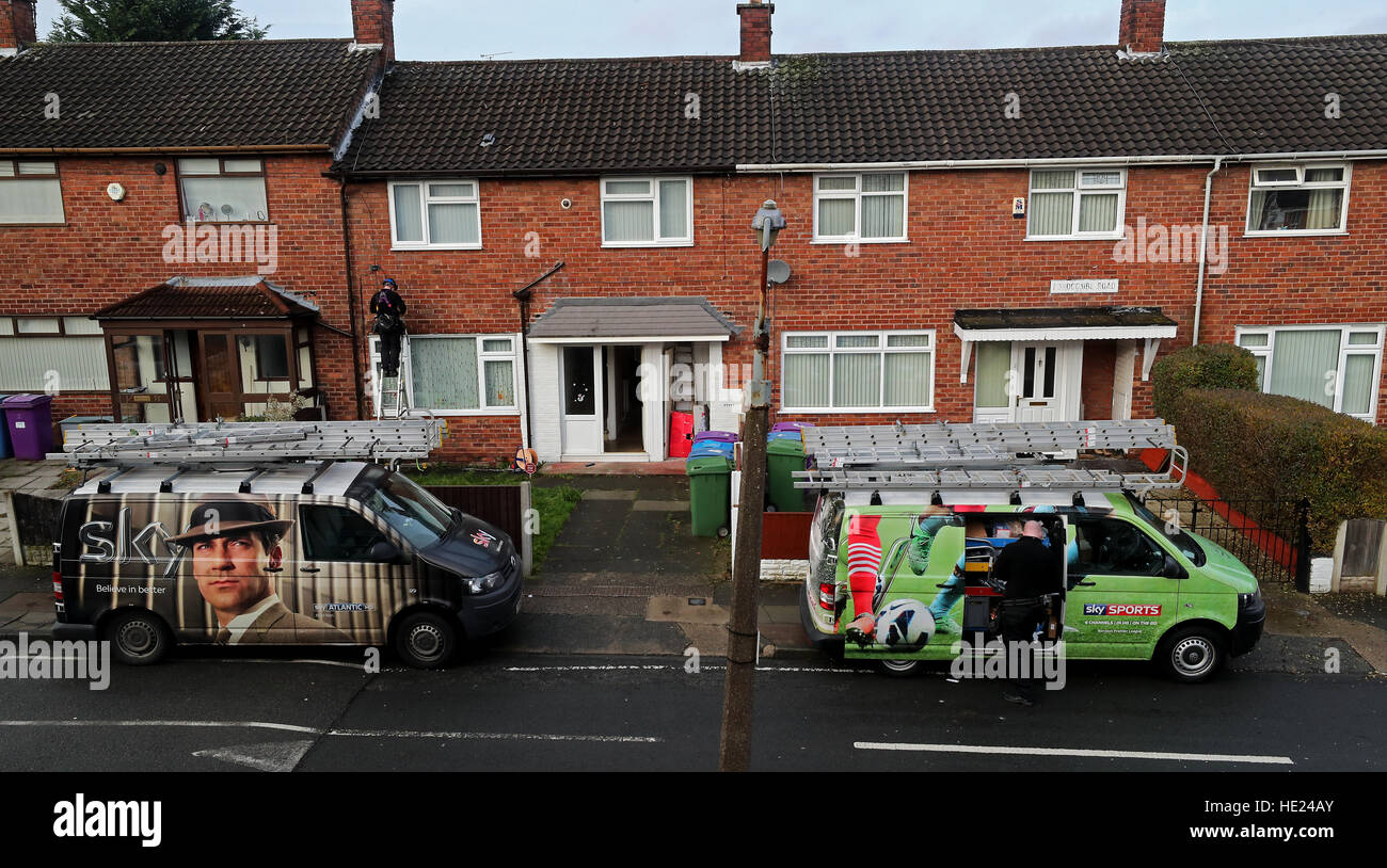 A Sky television engineer installs a satellite dish at an address in
