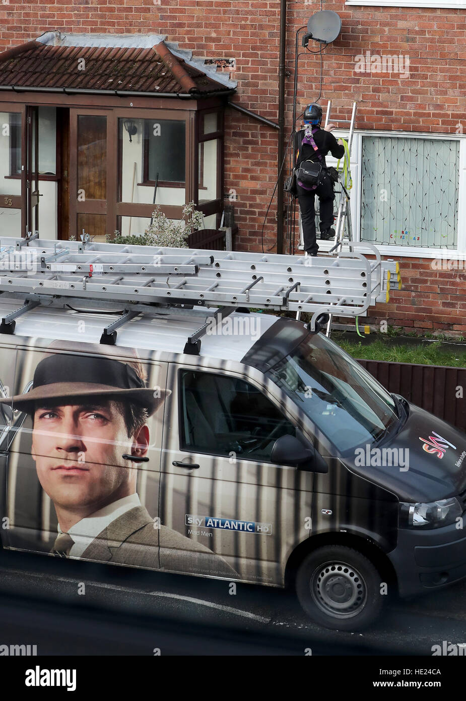 A Sky television engineer installs a satellite dish at an address in