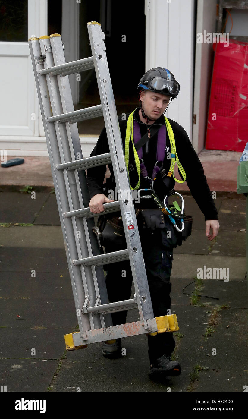 A Sky television engineer installs a satellite dish at an address in