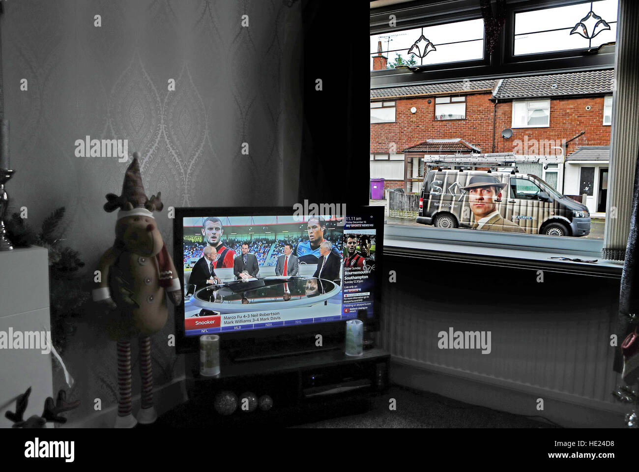 A Sky television engineer installs a satellite dish at an address in Liverpool Stock Photo Alamy
