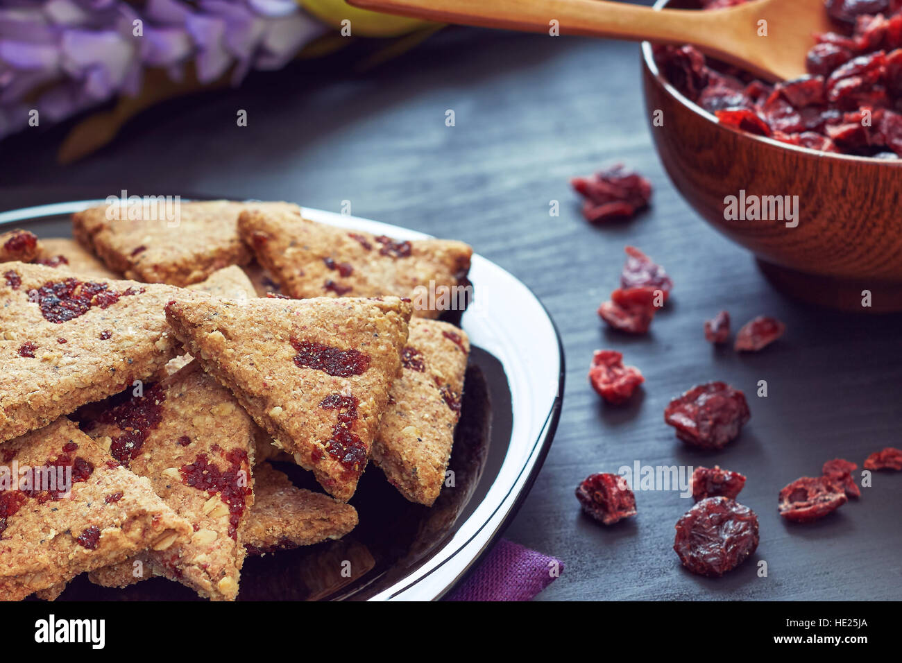 Whole wheat cookies with dried cranberries on black wooden background Stock Photo