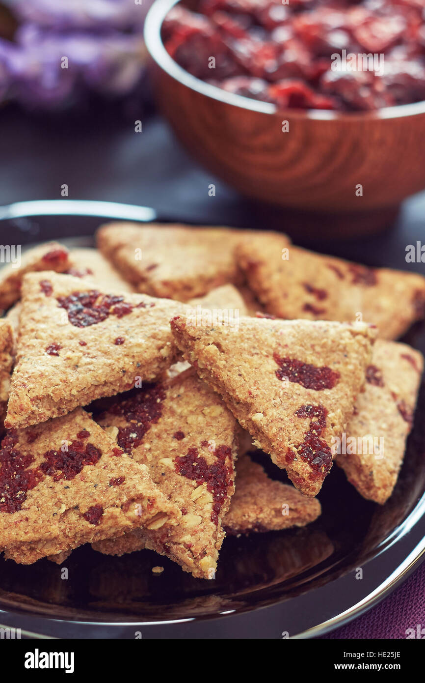 Whole wheat cookies with dried cranberries on black wooden background Stock Photo