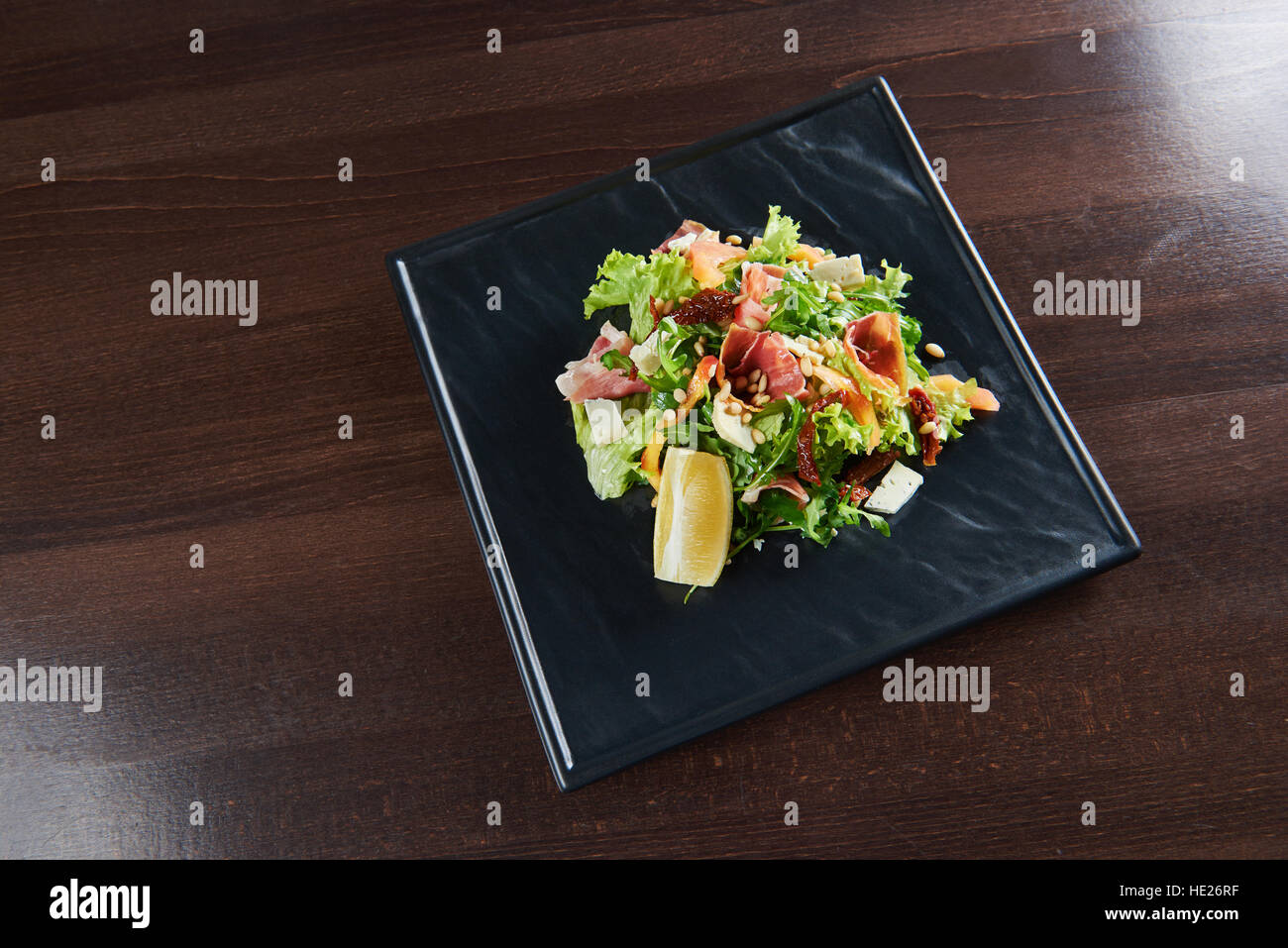 Healthy kitchen. Top view of a delicious prosciutto and arugula salad